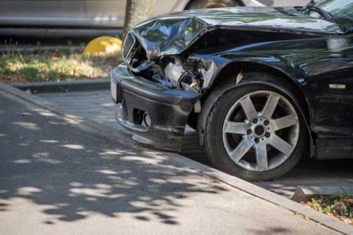 A car that has been damaged in a head-on collision.