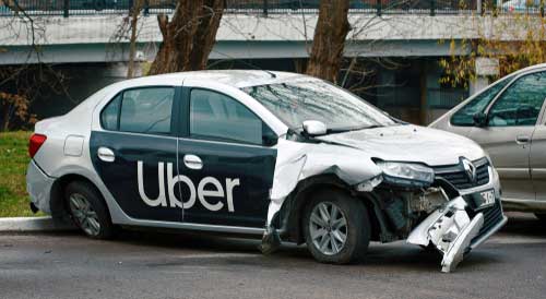 A damaged Uber vehicle that has been involved in an accident. 